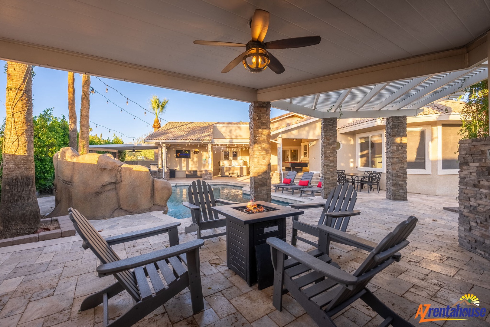 A stunning outdoor entertainment area with private fire pit, luxury seating, and elegant columns overlooks the resort-style pool and spacious patio, creating your perfect retreat for relaxation and gathering.