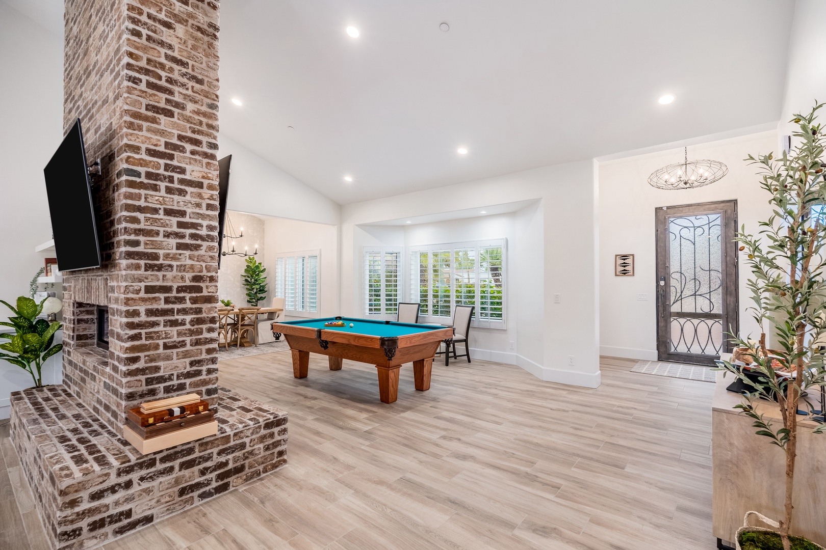 Challenge friends to a friendly game or unwind in your own entertainment haven, where rustic brick charm meets modern comfort beneath vaulted ceilings.