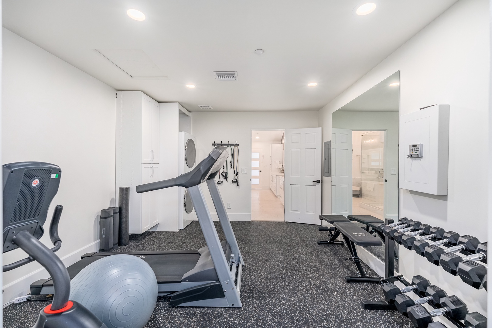Stay active during your getaway in this private fitness center, complete with cardio machines, free weights, and an exercise bench—your personal workout space awaits.
