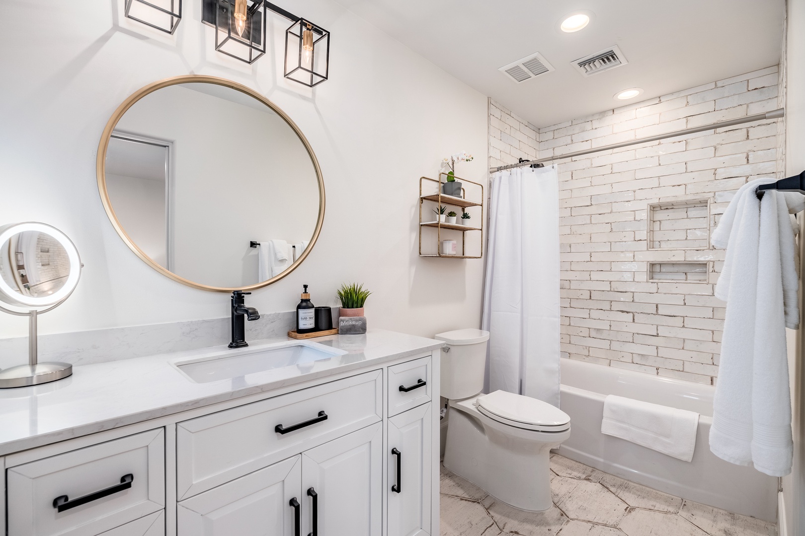Unwind in your beautifully designed bathroom featuring a luxurious tub-shower combo behind crisp white subway tile. The elegant vanity offers ample storage, while soft lighting and modern fixtures create a spa-like retreat.