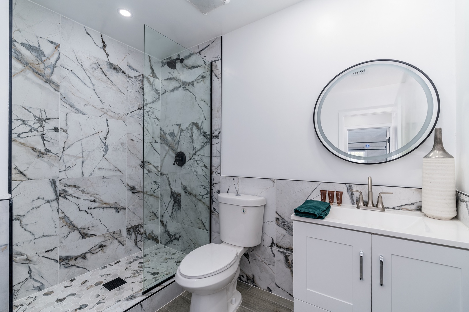 Step into your spa-like bathroom where stunning marble tiles and a sleek glass shower create a luxurious retreat for unwinding after each day's adventures.