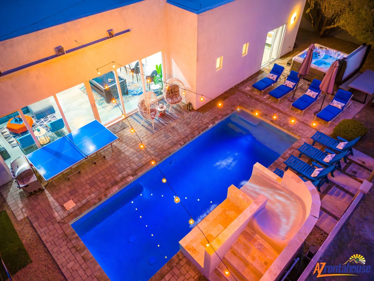 Dive into your private oasis with this stunning pool and hot tub, perfectly lit for magical evening swims.