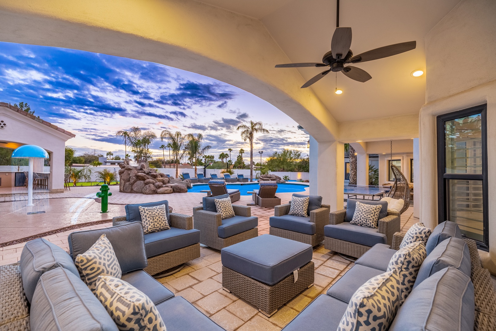 Unwind under your private covered patio with plush lounge seating and sweeping pool views. The desert sky stretches overhead, framing your perfect Arizona escape.