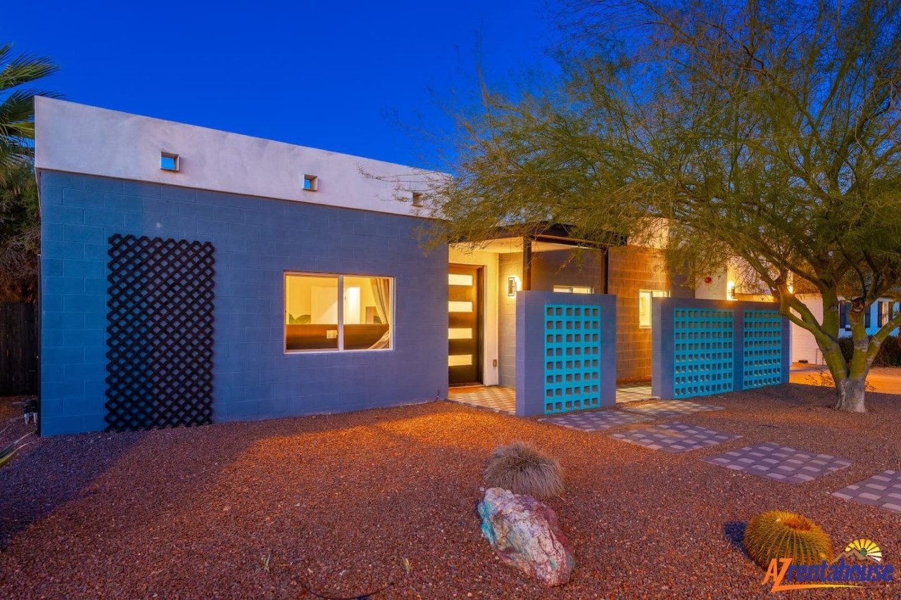 Modern desert retreat with contemporary architecture and warm evening lighting creates a welcoming arrival experience in the Southwest.
