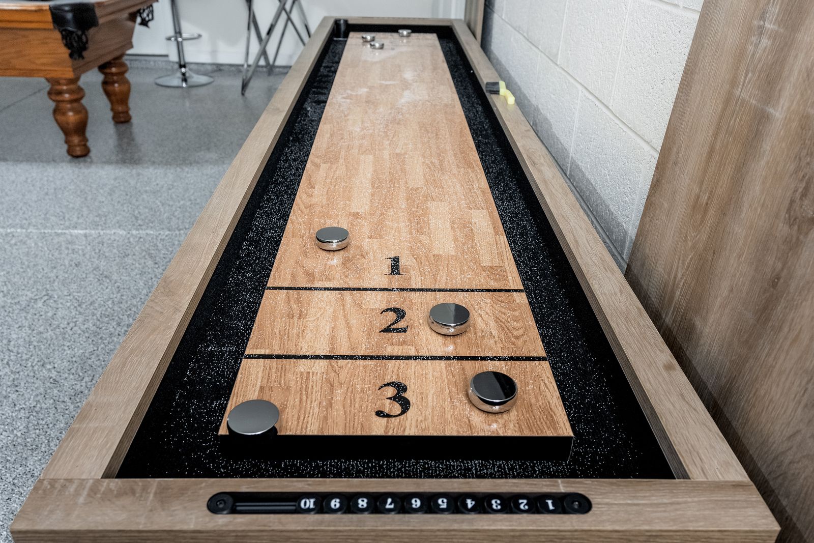 Challenge your friends to a classic game of shuffleboard—your very own entertainment awaits in this inviting game room, perfect for friendly competition and fun-filled evenings.