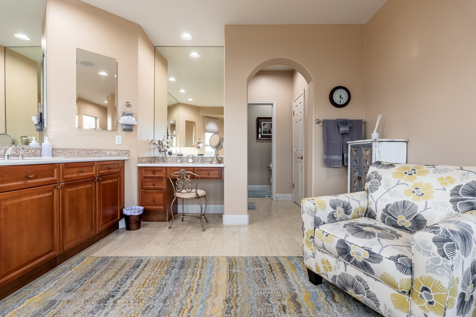 Step into your private retreat where a spacious en-suite blends comfort and elegance. Gleaming countertops, rich wood cabinetry, and a cozy seating nook create a spa-like escape where you can unwind in style.
