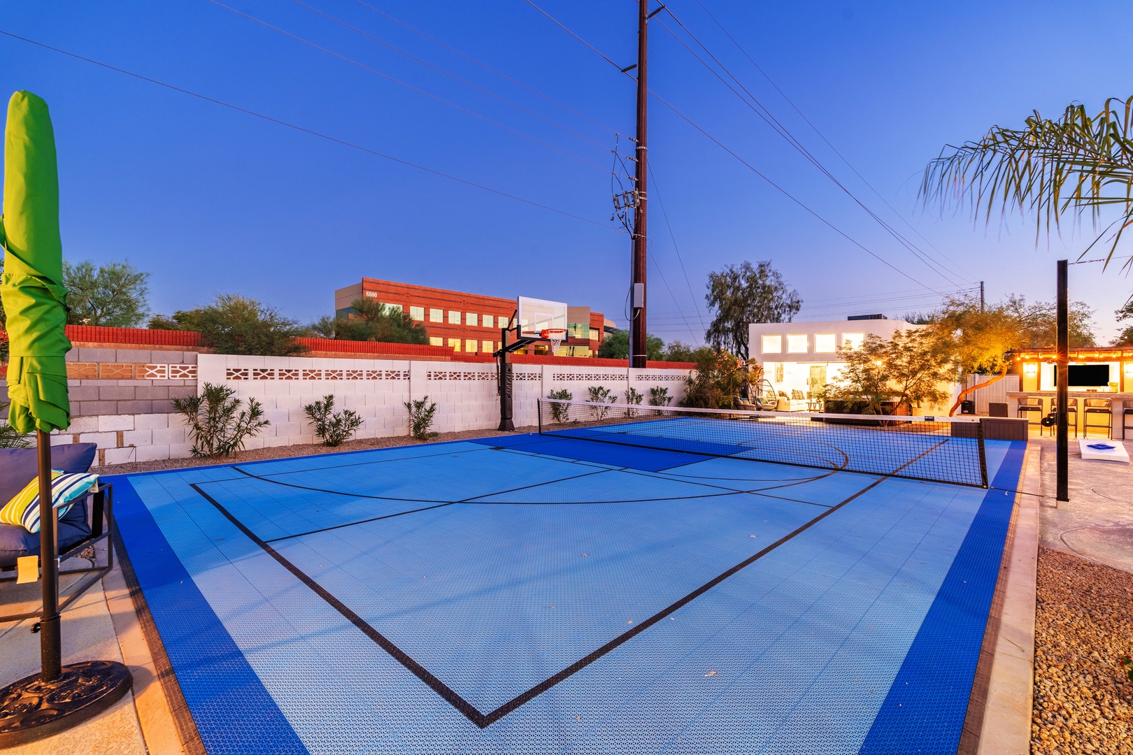Full-sized tennis court with professional-grade net and surface, lit for evening play and surrounded by landscaped grounds—ideal for friendly matches or active recreation during your stay.