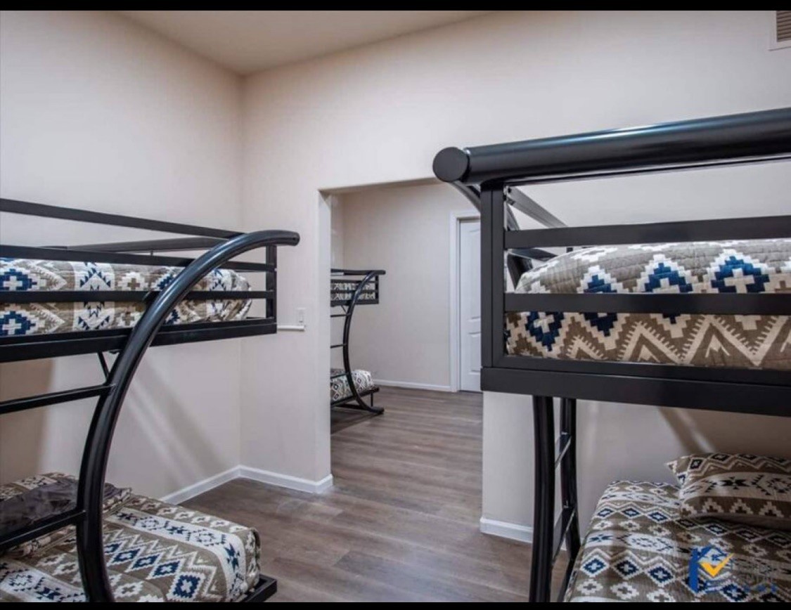 Sleep soundly in your cozy bunk room with stylish geometric linens and modern metal frames for a comfortable stay.