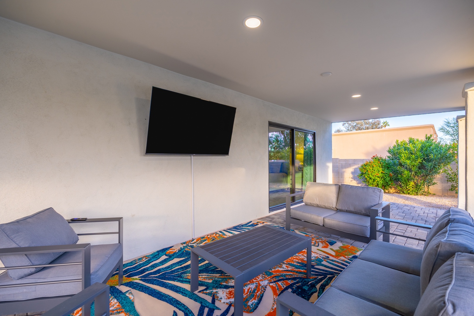 Settle into your private covered patio where modern comfort meets desert views. Stream your favorite shows on the flat-screen TV while enjoying fresh air and tranquil garden scenery just beyond.
