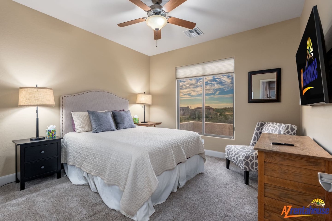 Your peaceful bedroom features a plush king bed with soft linens, ceiling fan, and desert views from your private window.