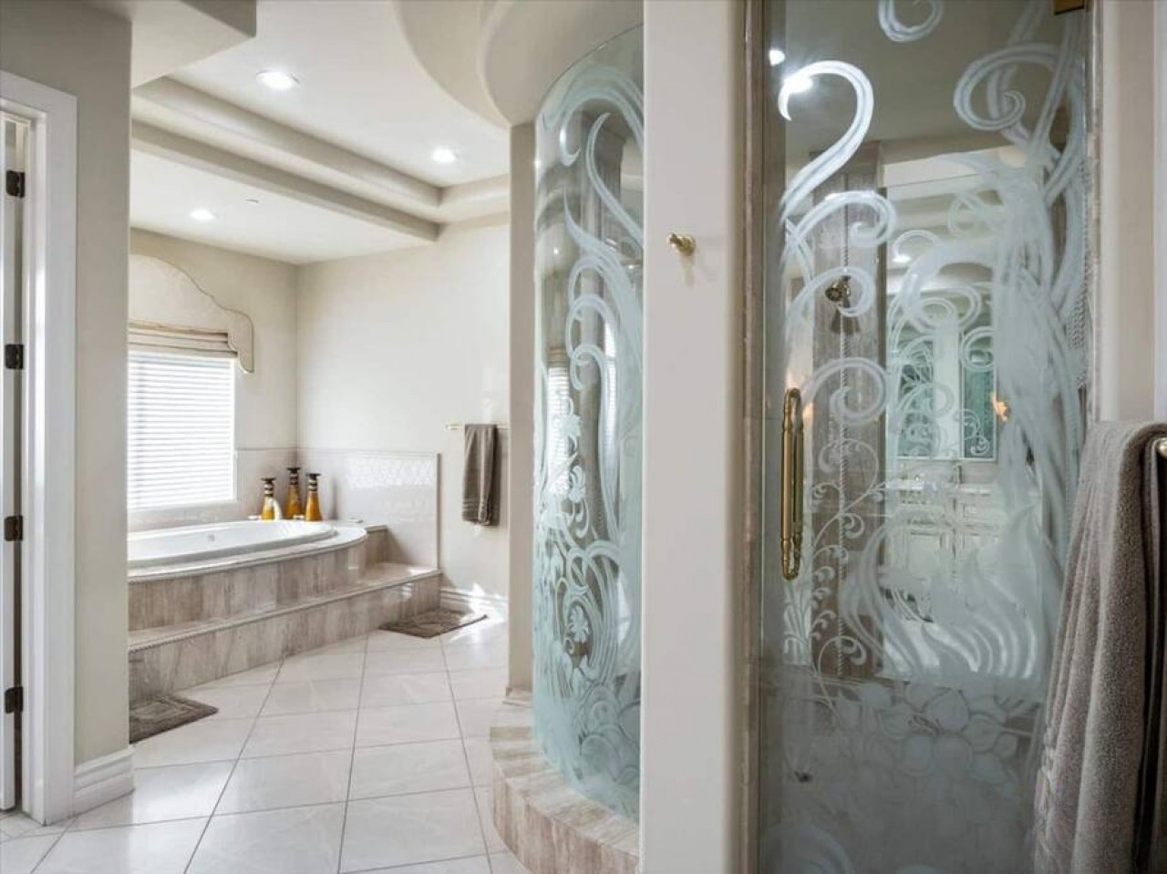 Step into your serene spa-like bathroom, where natural light floods in and a luxurious soaking tub awaits you for ultimate relaxation after your day.