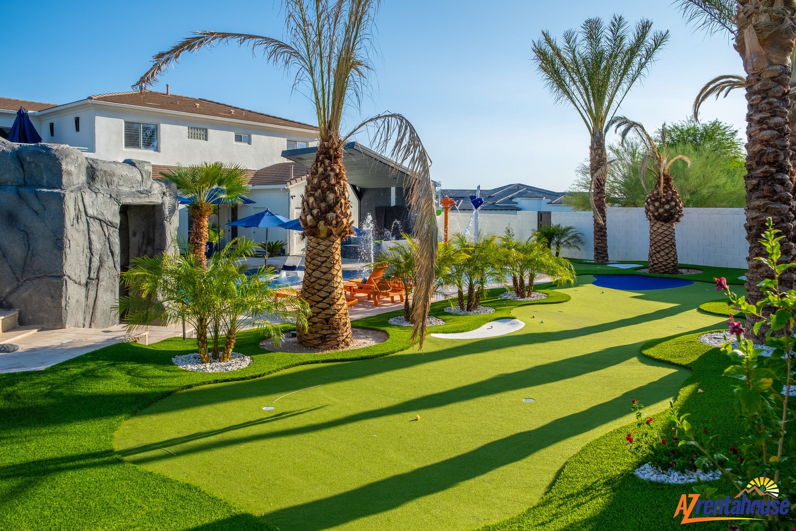 Your private paradise awaits with lush putting green, sparkling pool, and tropical palms creating the perfect resort-style retreat.