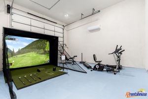 Step into your private fitness zone with a golf simulator and premium equipment for the perfect workout or golf practice session.