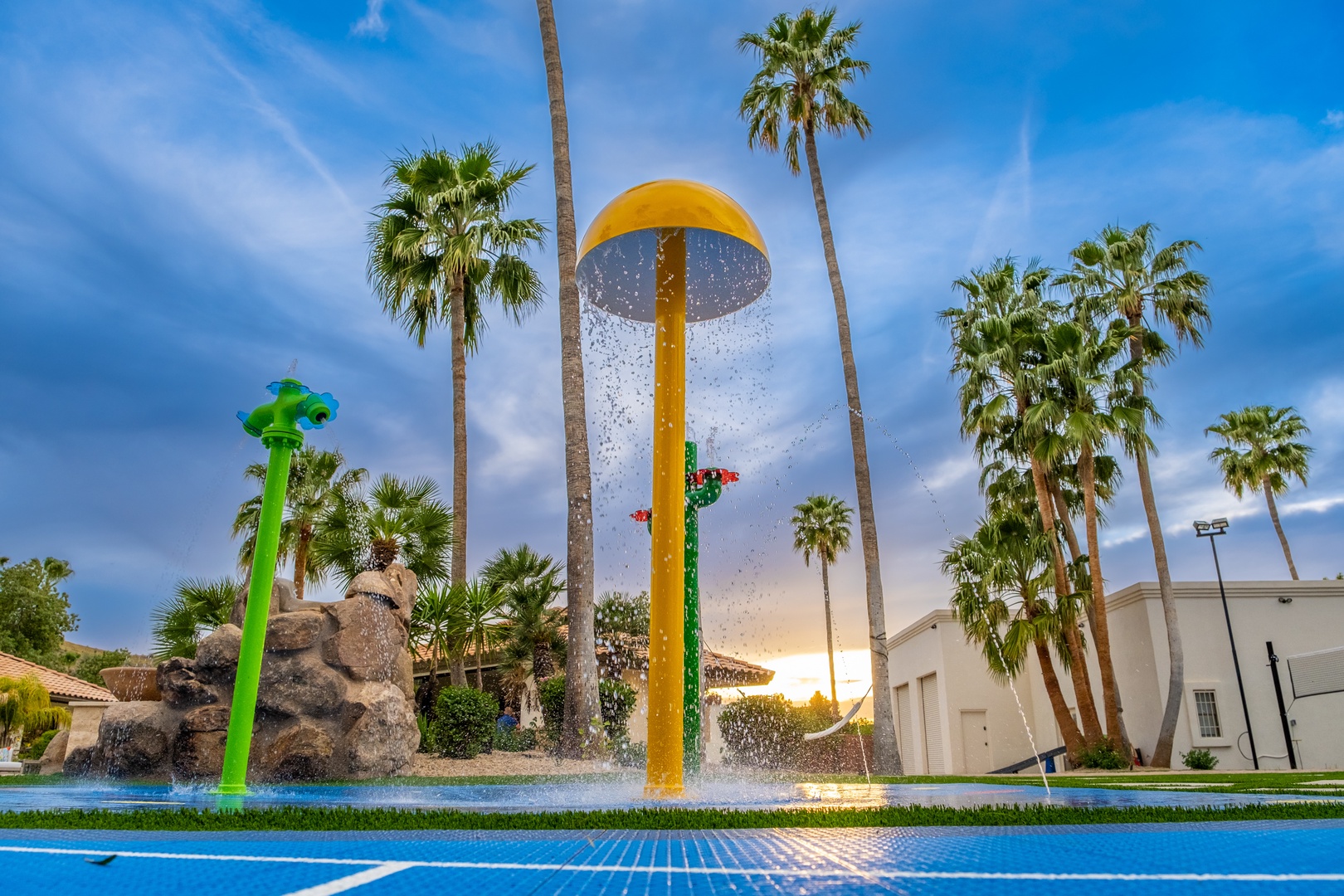 The resort's splash zone features colorful water features and towering palms, promising playful afternoons under sunny skies for all ages.
