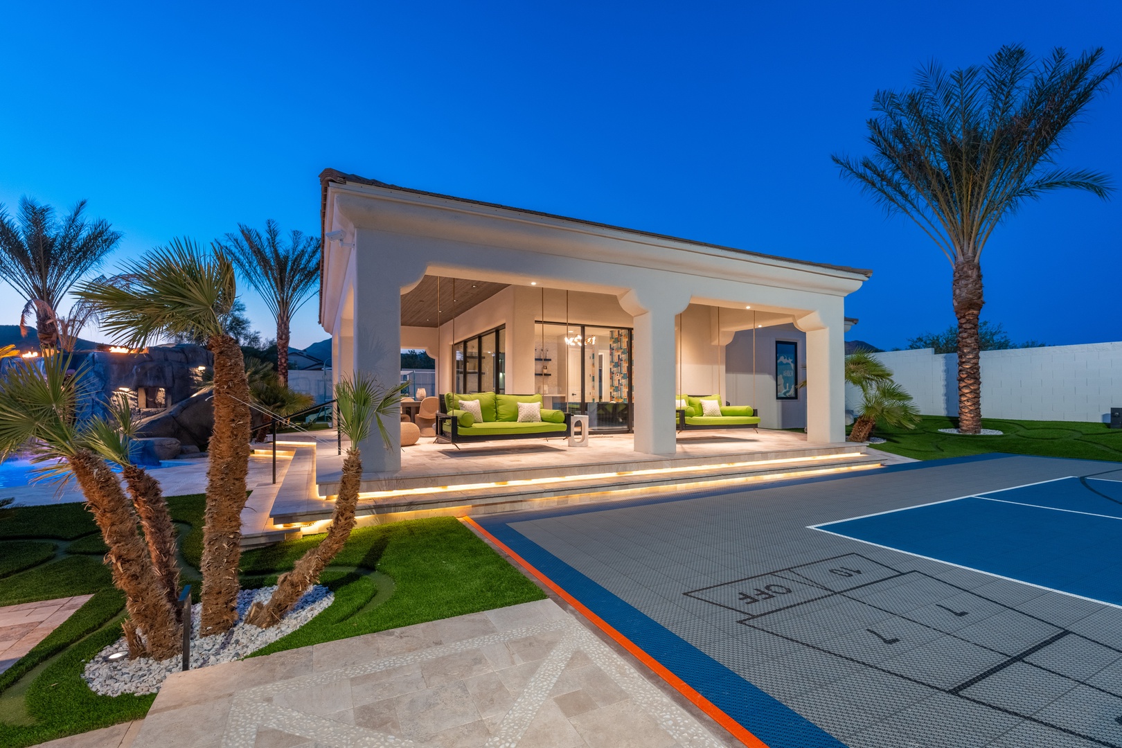 A luxury villa showcasing modern architecture and stunning landscaping, featuring elegant outdoor spaces perfect for an upscale retreat.