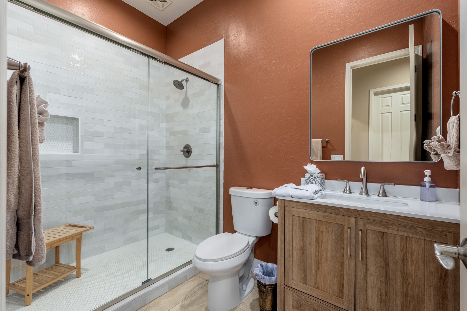 Step into your private sanctuary with a spacious walk-in shower, warm terracotta tones, and modern fixtures that create a spa-like retreat for your daily refresh.