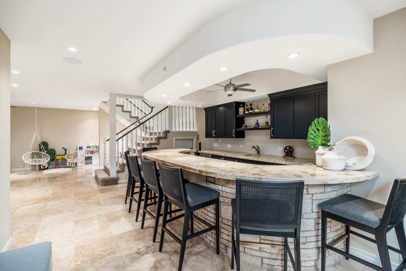 Step into your private entertainment haven with a stunning stone-accented bar, perfect for gathering friends and family. The open layout flows effortlessly, inviting you to unwind and make memories.