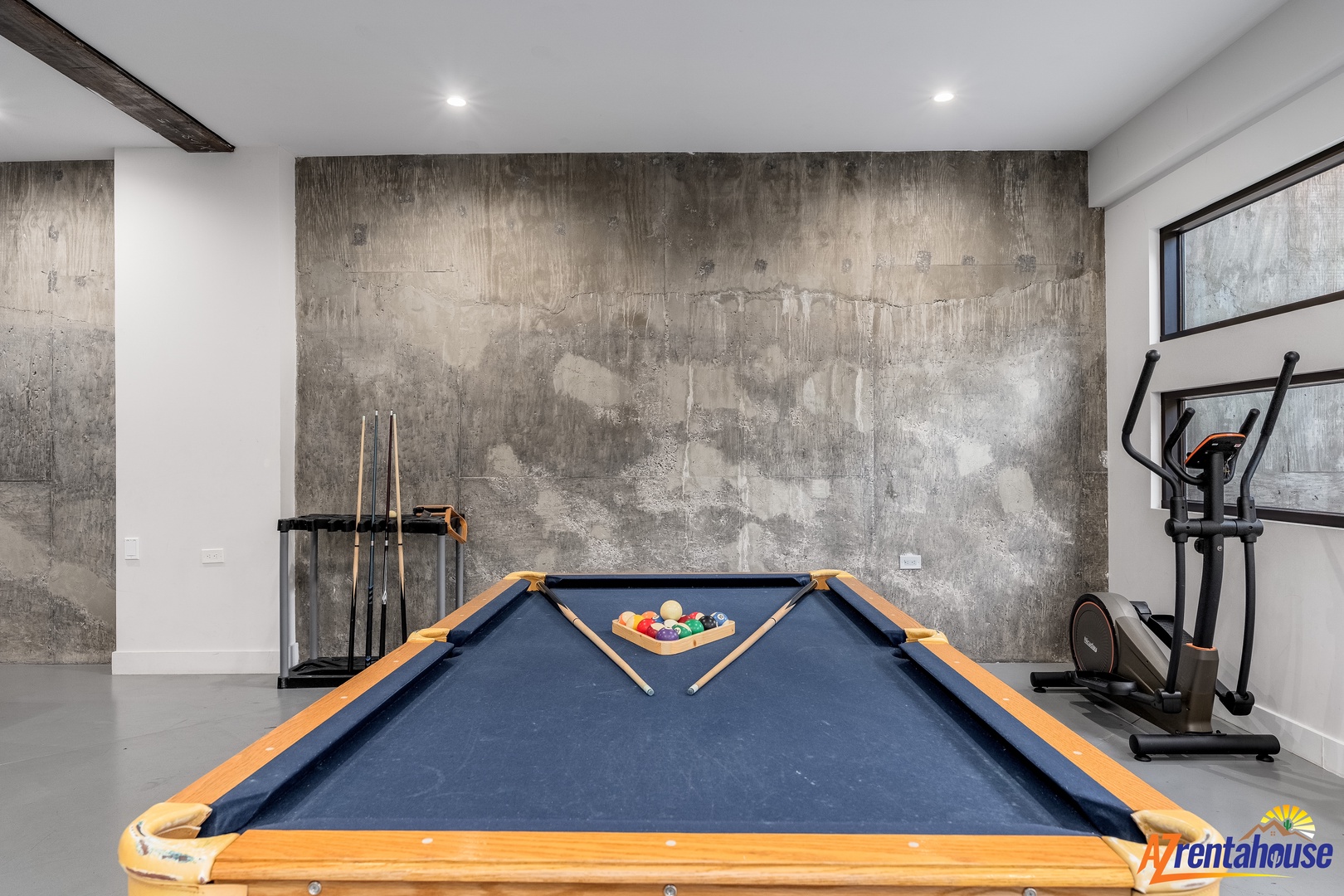 Your private game room awaits with a full pool table and fitness equipment, perfect for unwinding after exploring the area.