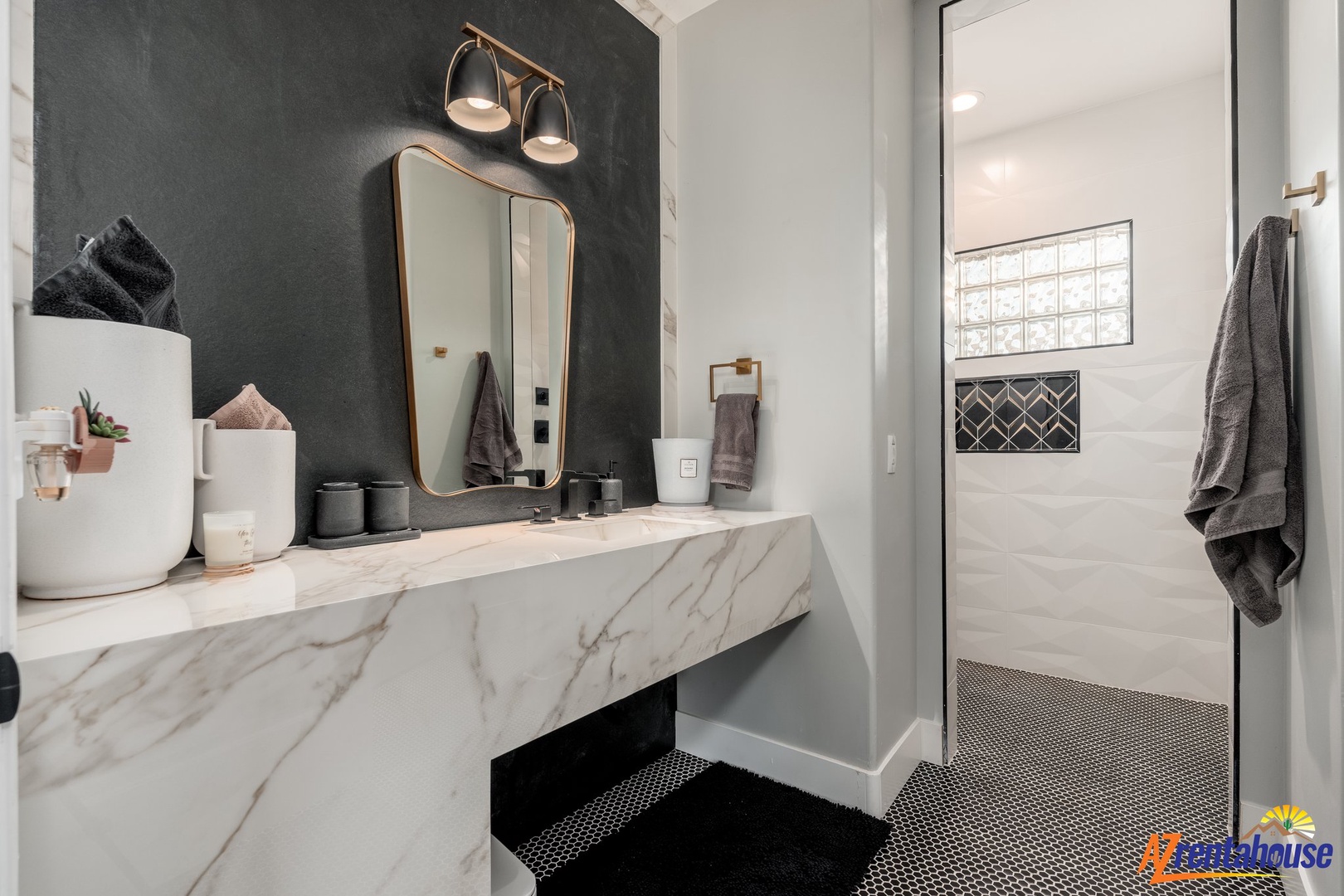 Pamper yourself in this stylish spa-like bathroom with floating marble vanity, designer lighting, and walk-in shower.