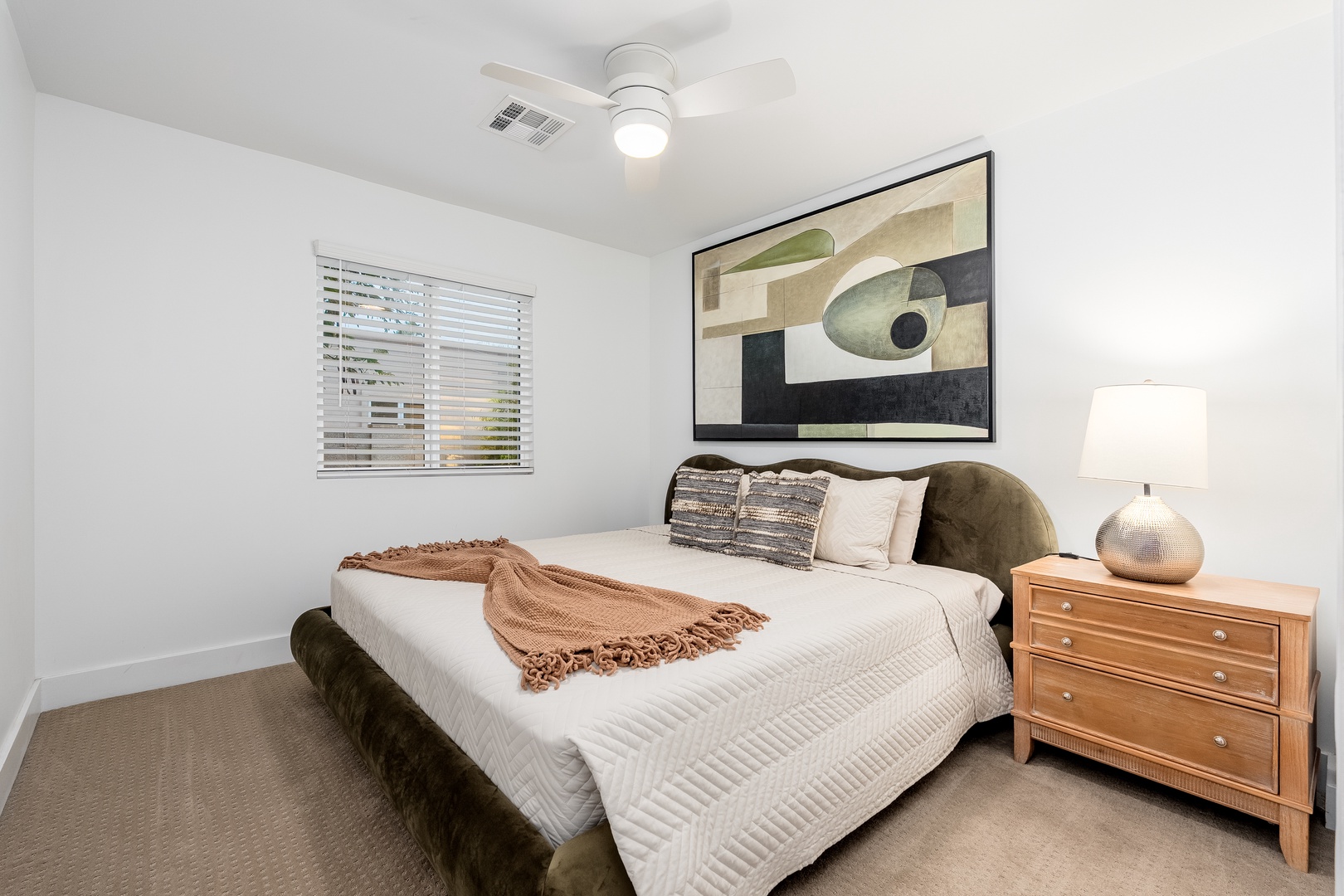 Sink into crisp linens and plush pillows in your tranquil bedroom retreat, styled with modern art and warm natural light. A peaceful space just for you.