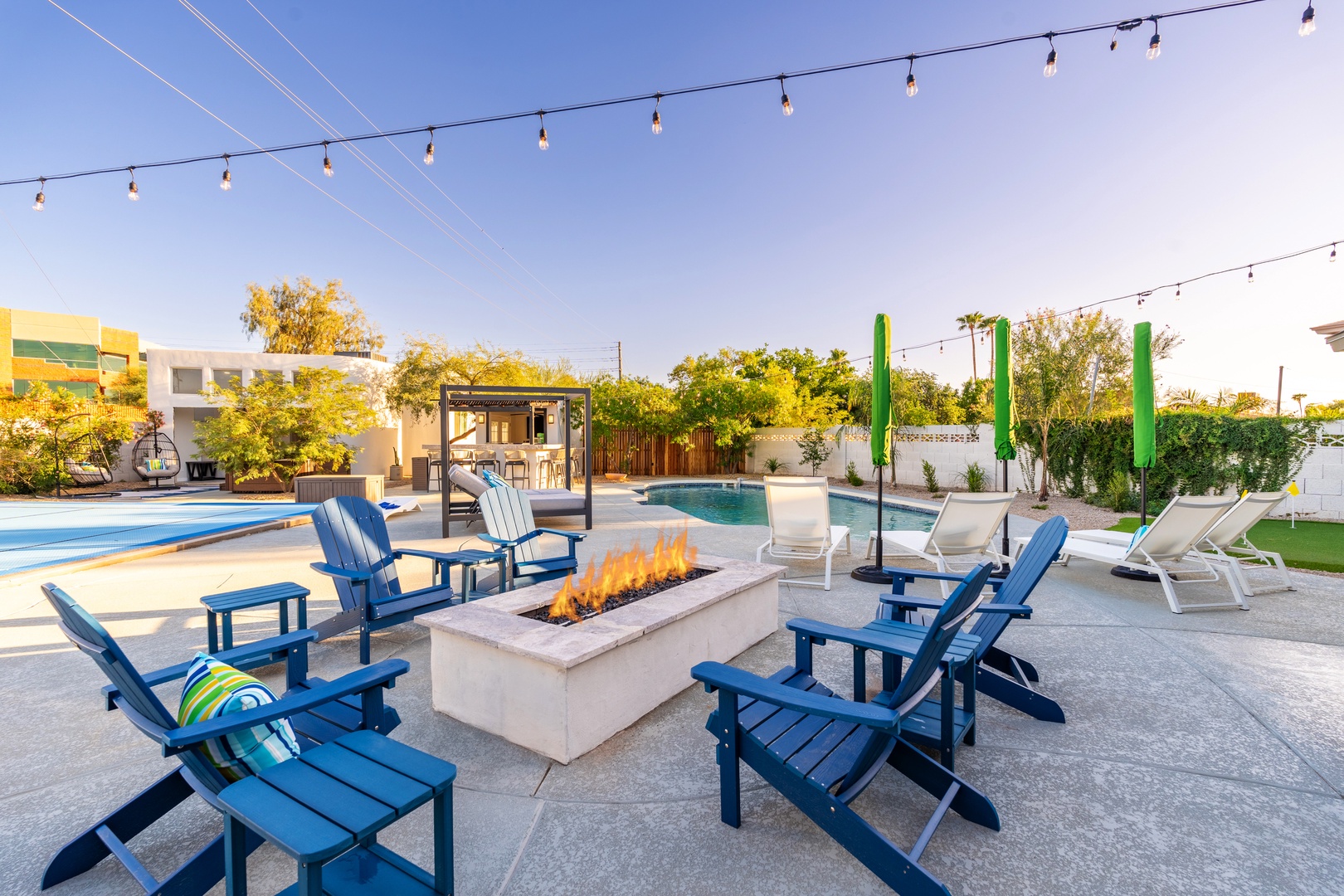 Gather around the firepit with loved ones as string lights glow overhead, then cool off in the sparkling pool or unwind on a sunbed under the open sky.
