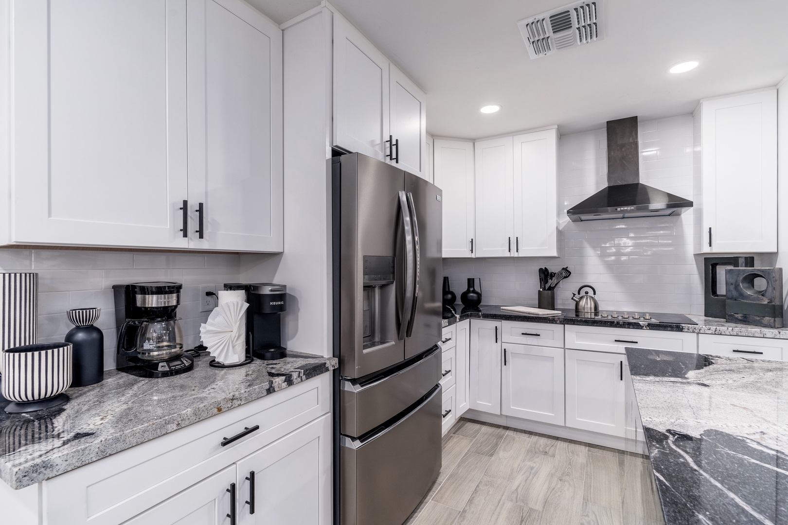 You'll love preparing meals in this bright, fully equipped kitchen featuring modern appliances, sleek granite countertops, and plenty of cabinet space for all your cooking needs.