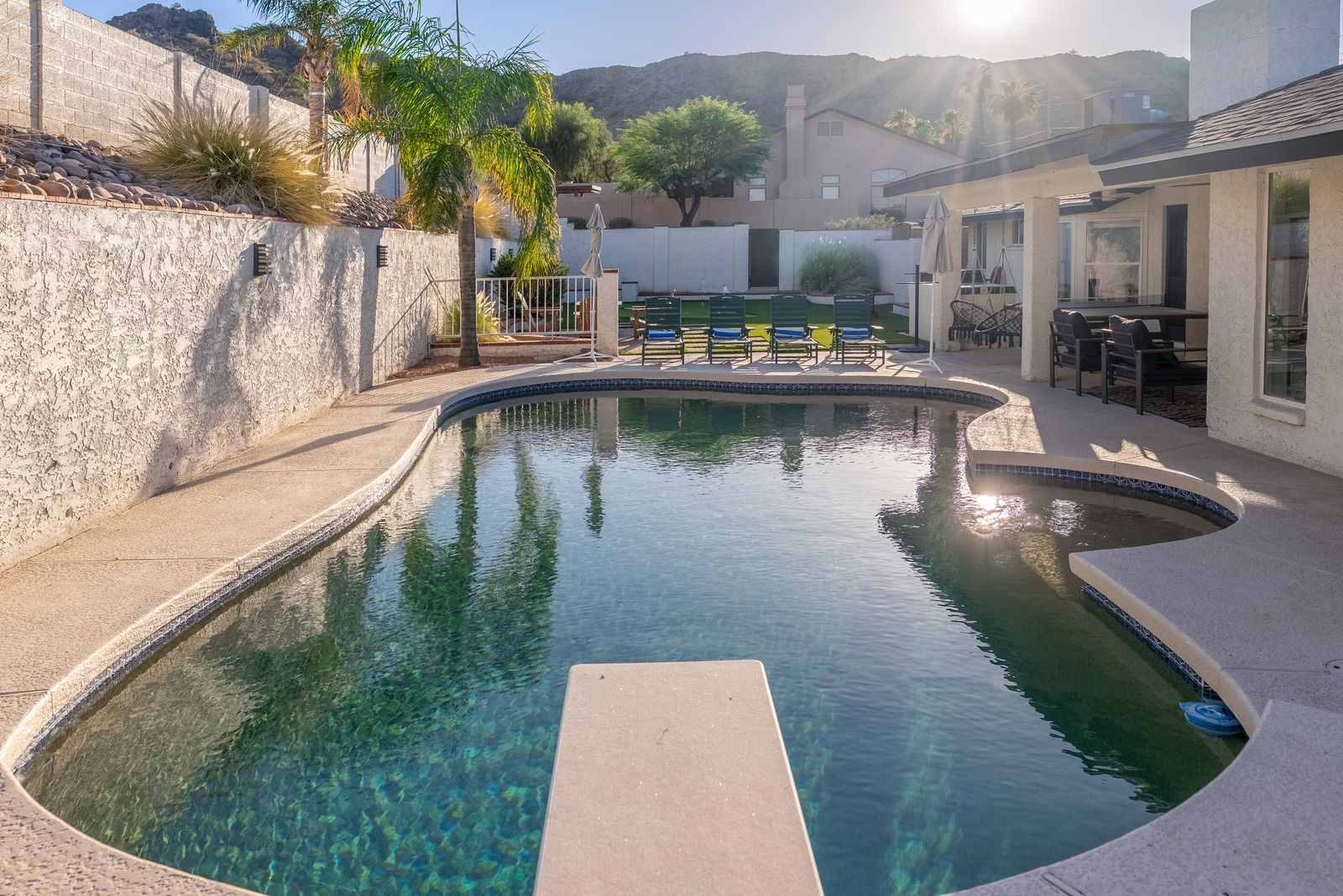 Dive into your private oasis—crystal-clear waters, mountain views, and plenty of loungers await your sun-soaked afternoons in this spacious backyard retreat.