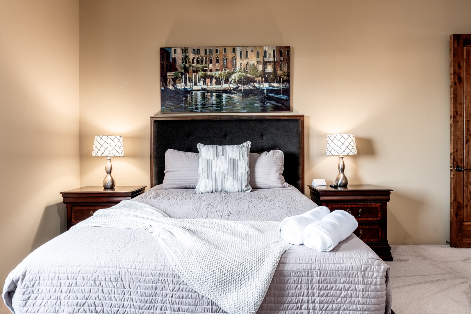 Sink into crisp linens and plush pillows after a day of exploring. Your bedroom features elegant nightstands, warm lighting, and Venice-inspired art to inspire your adventures.