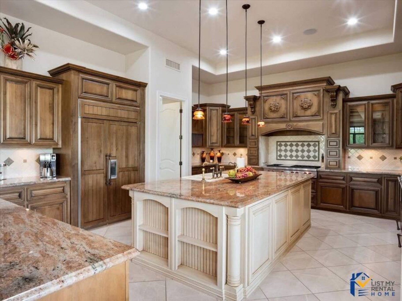 Your dream kitchen awaits with rich cabinetry, granite counters, and elegant pendant lighting creating the perfect space for culinary adventures.