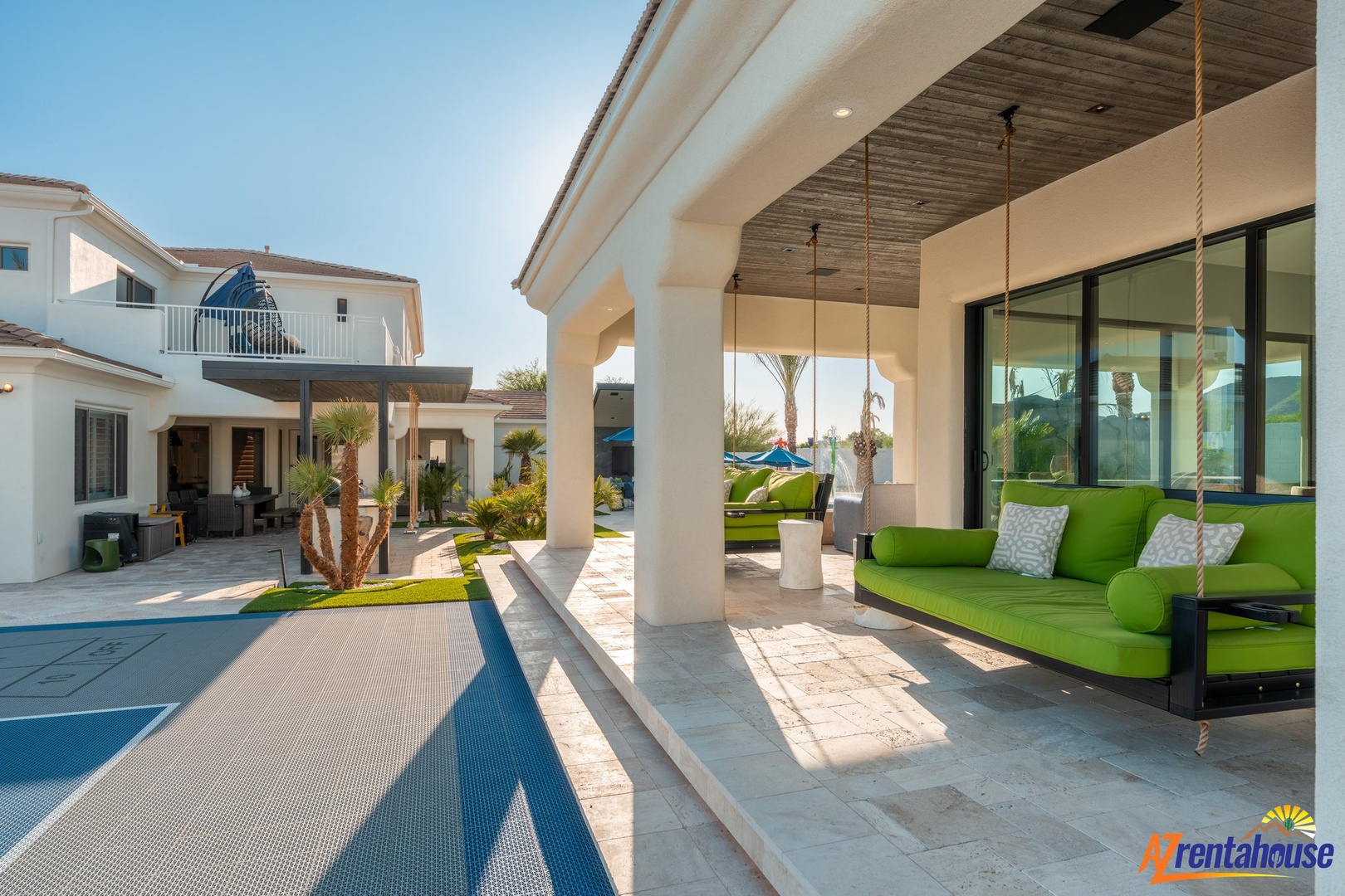 Relax on your private hanging daybed overlooking the stunning pool terrace, where comfort meets luxury in this serene outdoor sanctuary.
