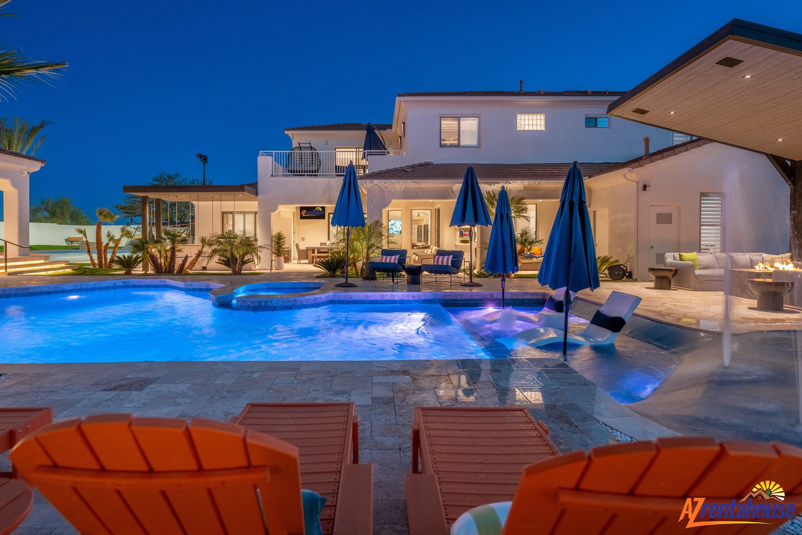 Stunning modern villa at twilight featuring sparkling pool, elegant outdoor spaces perfect for sunset gatherings.
