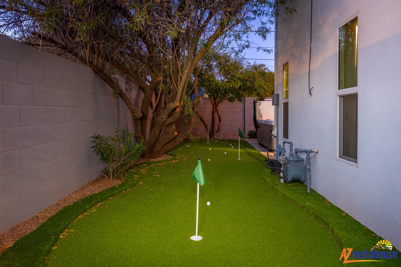 Practice your putting skills on your private miniature golf green, complete with flag and gentle evening lighting in the courtyard.