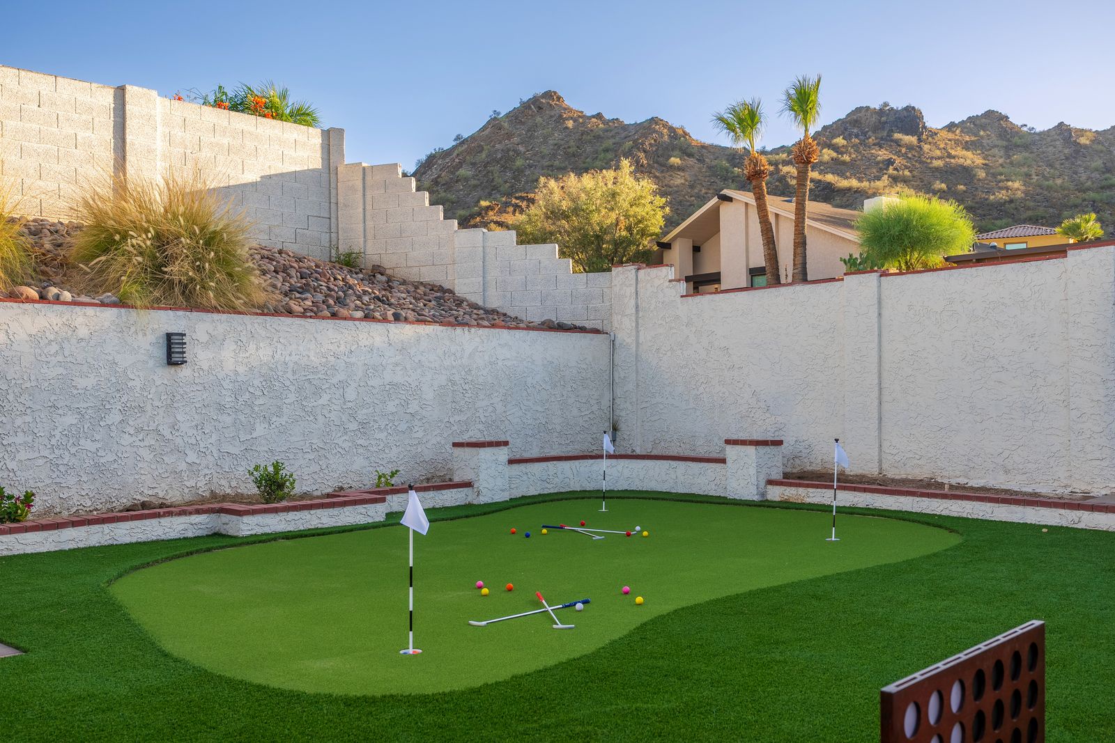 Practice your putting skills on your private mini golf green, surrounded by desert mountain views and swaying palms—perfect for friendly competitions under sunny Arizona skies.