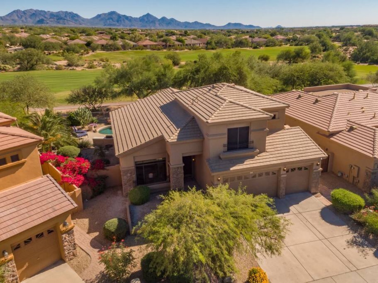 Stunning desert home nestled on prestigious golf course with dramatic mountain backdrop and lush landscaping throughout the community.