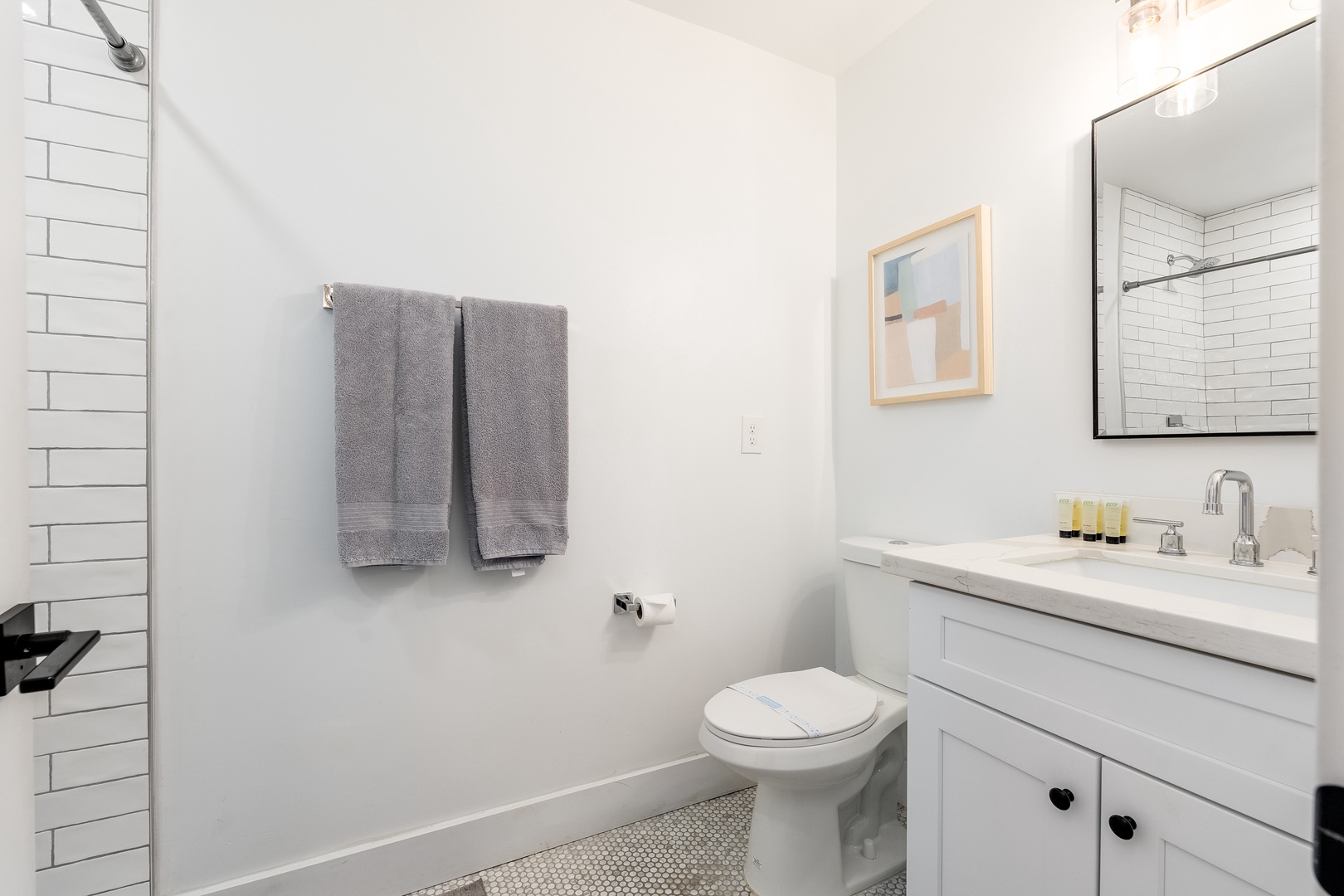 Step into your bright, modern bathroom with classic subway tile shower, plush towels, and fresh amenities—a clean, calming space to refresh yourself each day.