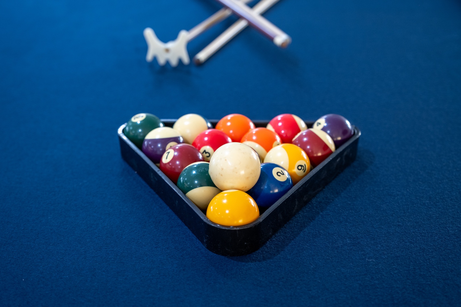 Colorful billiard balls racked and ready for your next friendly match on the felt—perfect for unwinding after a day of adventure.