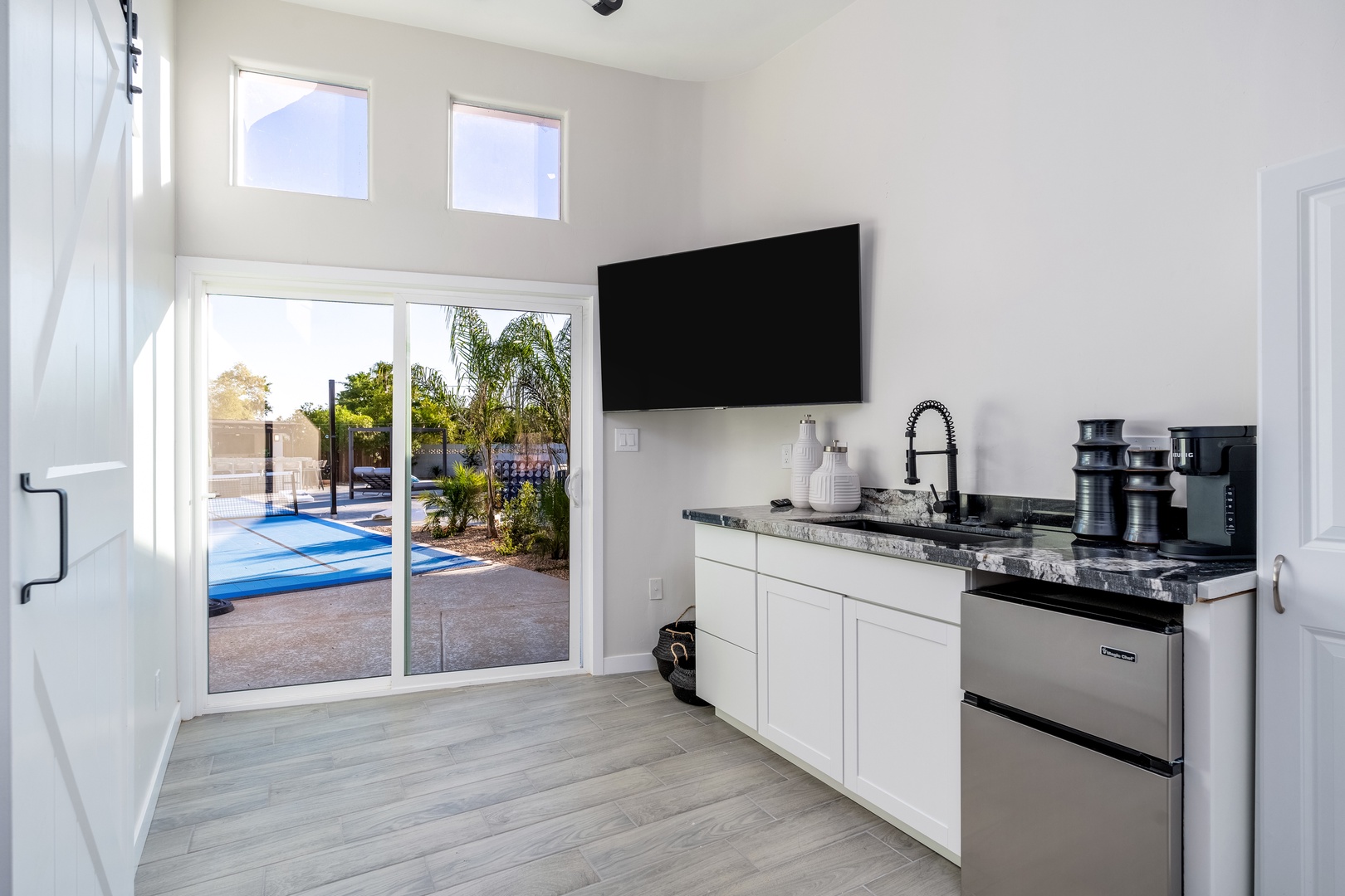 Your private kitchenette opens to the pool area, combining sleek countertops, modern appliances, and entertainment for a refreshing stay.