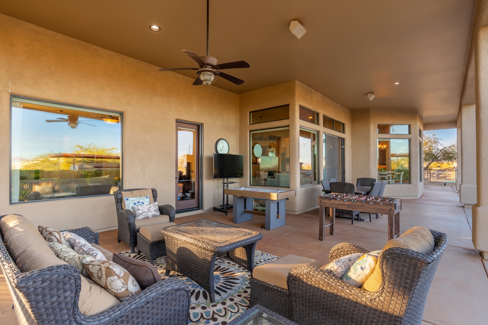 Your covered patio offers a relaxing outdoor living room with comfortable seating, ceiling fans, and beautiful desert views—perfect for unwinding after a day of adventure.