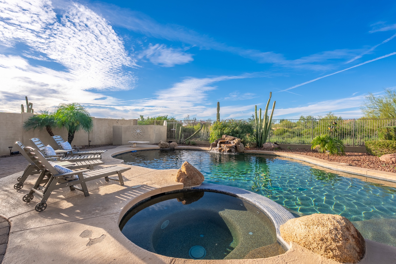 Soak in your private hot tub or lounge poolside with stunning desert views. Natural rock features and lush landscaping create your own peaceful oasis under Arizona skies.