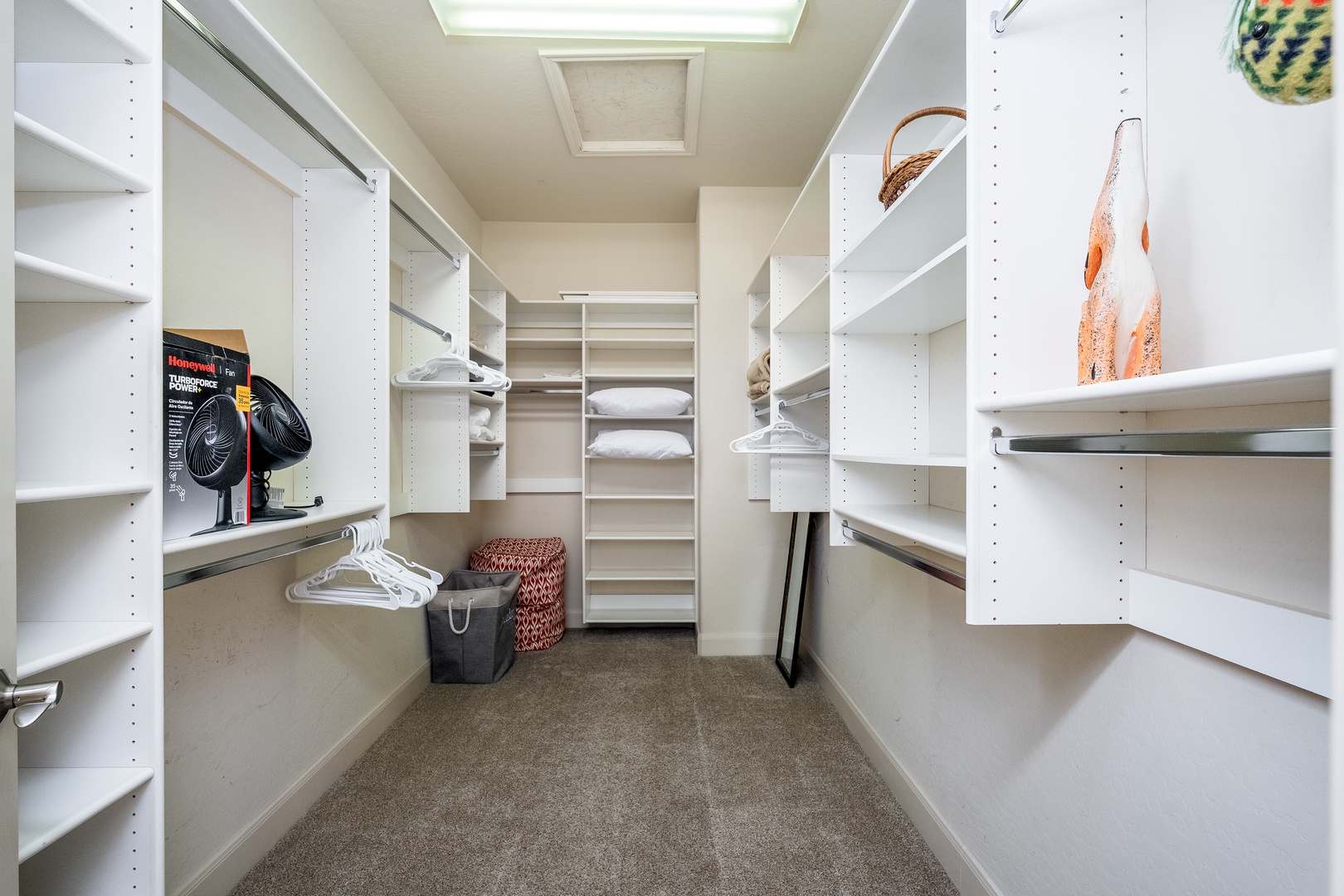 Generous walk-in closet with custom shelving and hanging rods to keep your wardrobe organized and accessible throughout your stay.