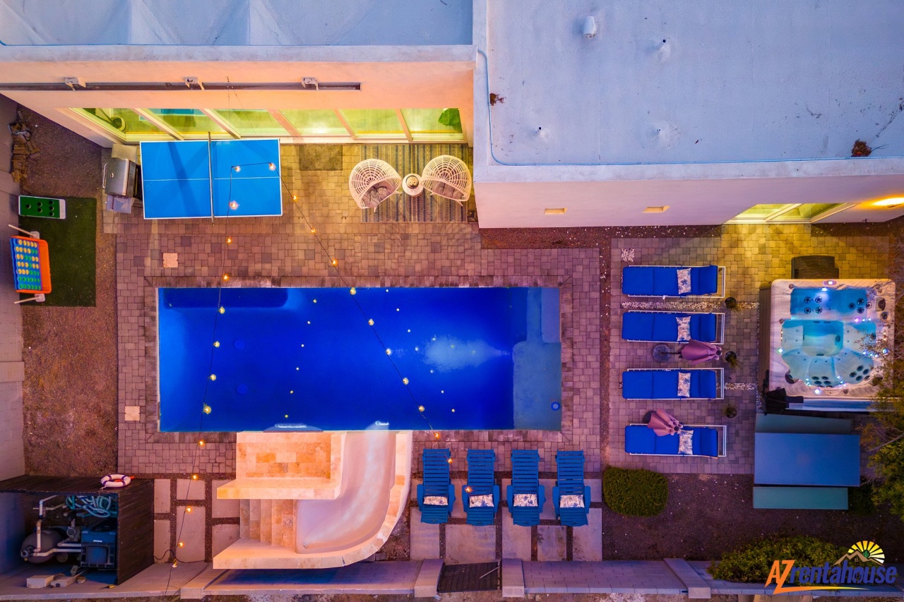 Aerial view of the resort's stunning pool complex featuring multiple pools, hot tub, and poolside lounging areas.