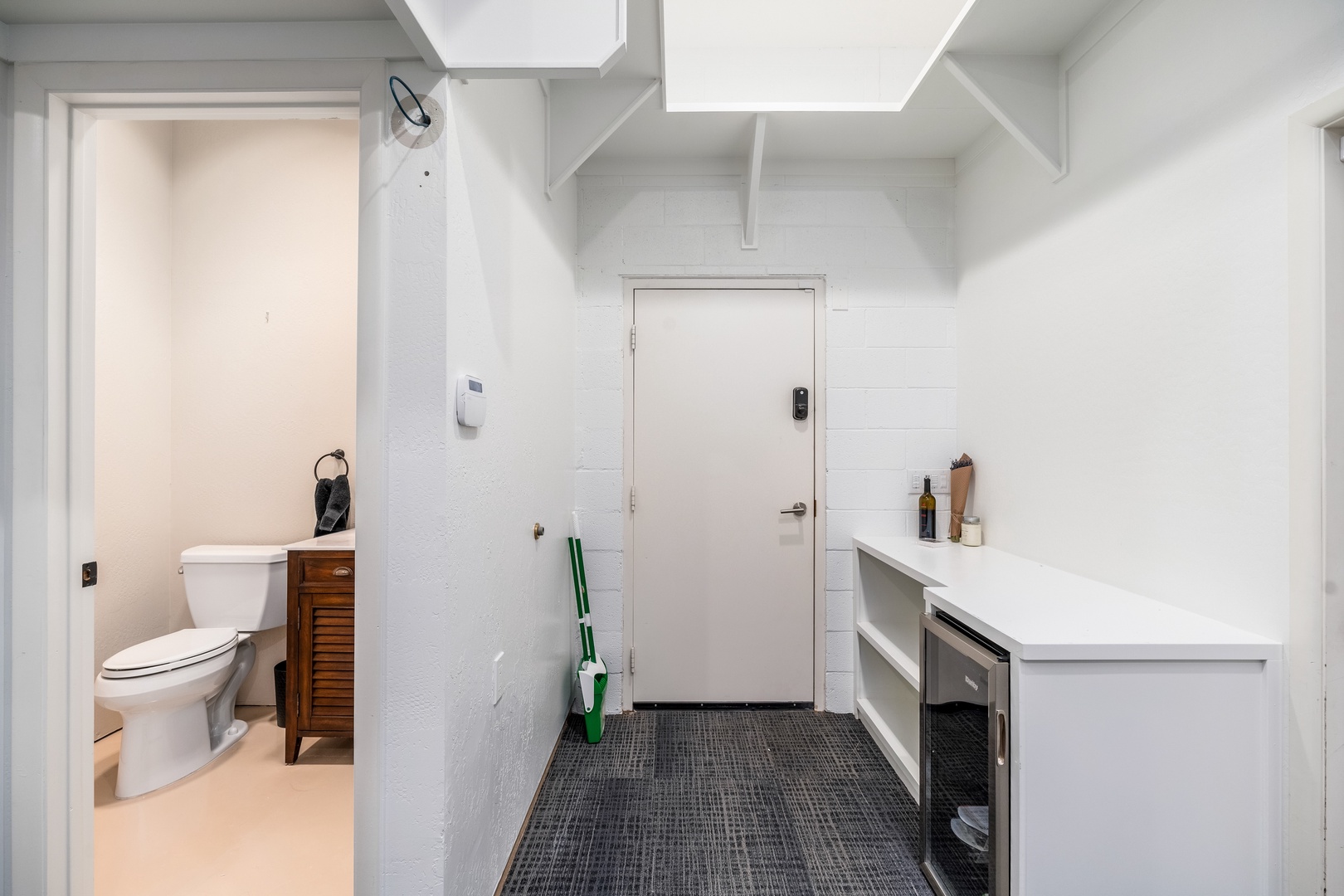 This freshly painted entryway with exposed brick walls leads to your private bathroom with vintage-inspired fixtures, offering both charm and convenience during your stay.