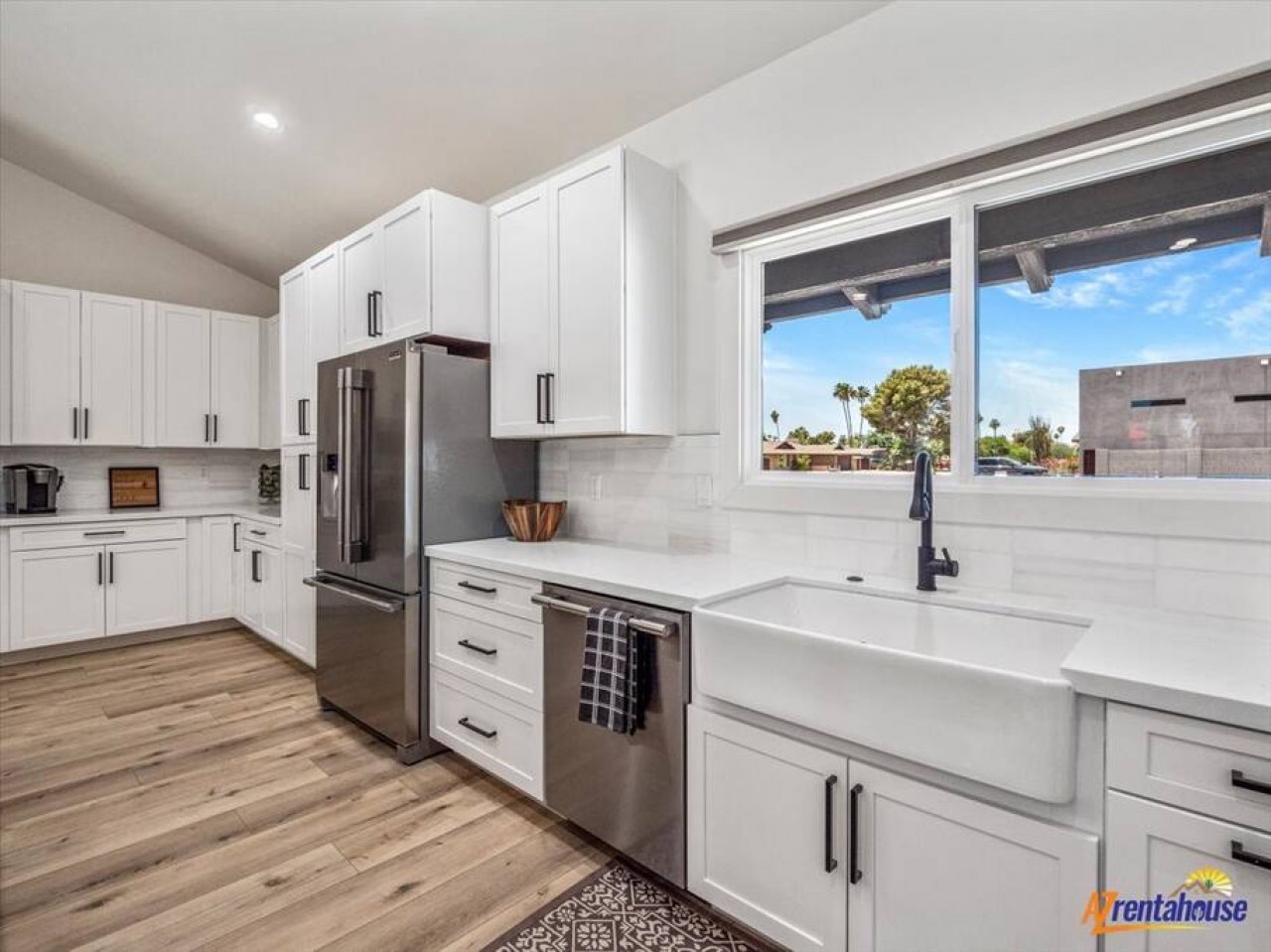 Your modern kitchen features pristine white cabinetry, premium stainless appliances, and a spacious island for meal prep.