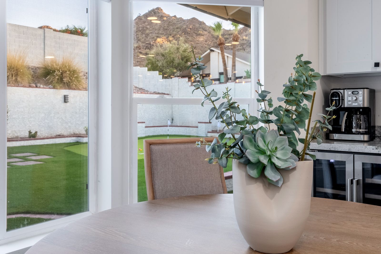Relax at your dining table with desert mountain views and access to your private backyard oasis, complete with lounge seating and natural landscaping.