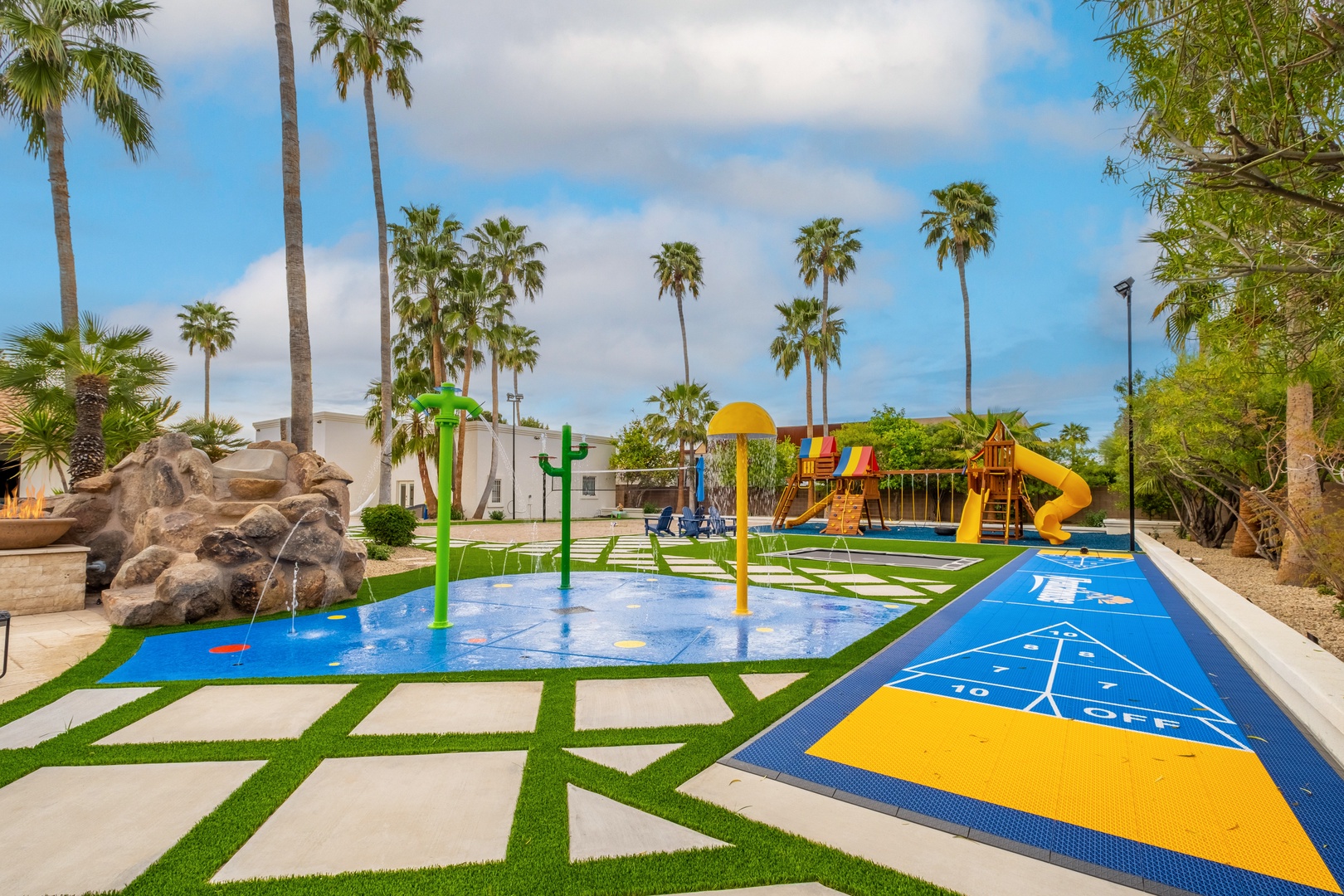 Your family will love this vibrant outdoor play area with splash pads, slides, and games—all set among swaying palms and sunny skies for endless fun.