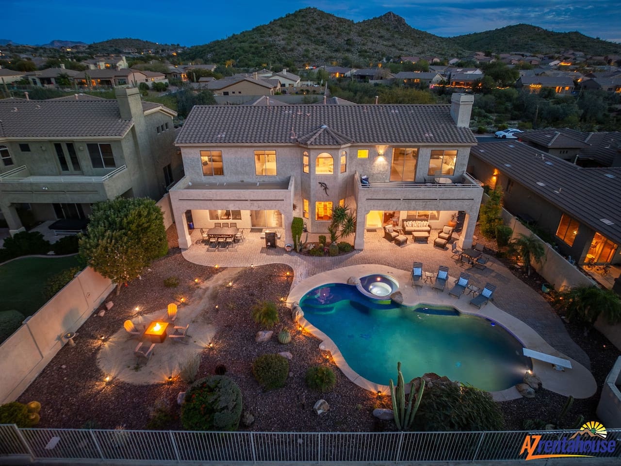 Stunning desert estate featuring private pool and hot tub with mountain backdrop. Spacious outdoor entertaining areas perfect for memorable evenings.