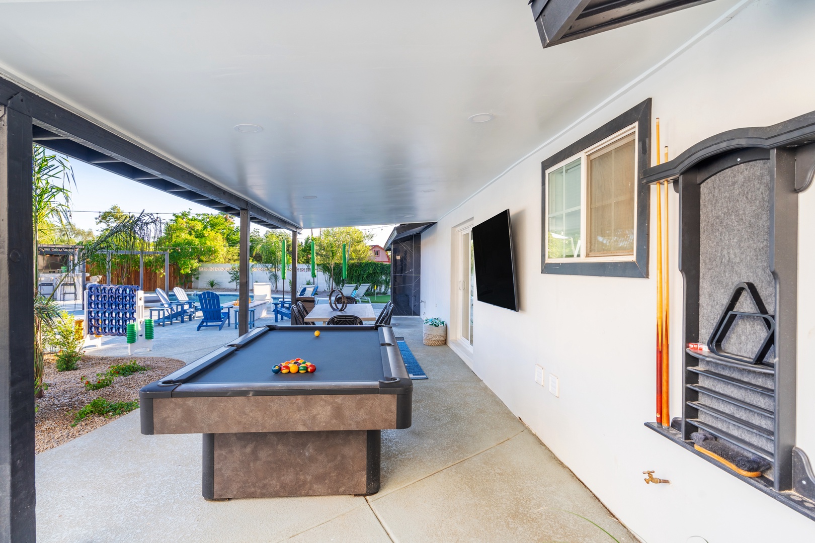 Challenge your friends to a game of pool under the covered patio, then step outside to lounge by the sparkling pool surrounded by lush greenery and comfortable seating.