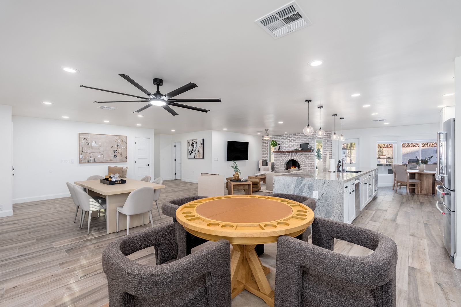 Gather around the custom game table or relax in your spacious open-concept living area with modern fireplace, gourmet kitchen, and stylish finishes throughout.