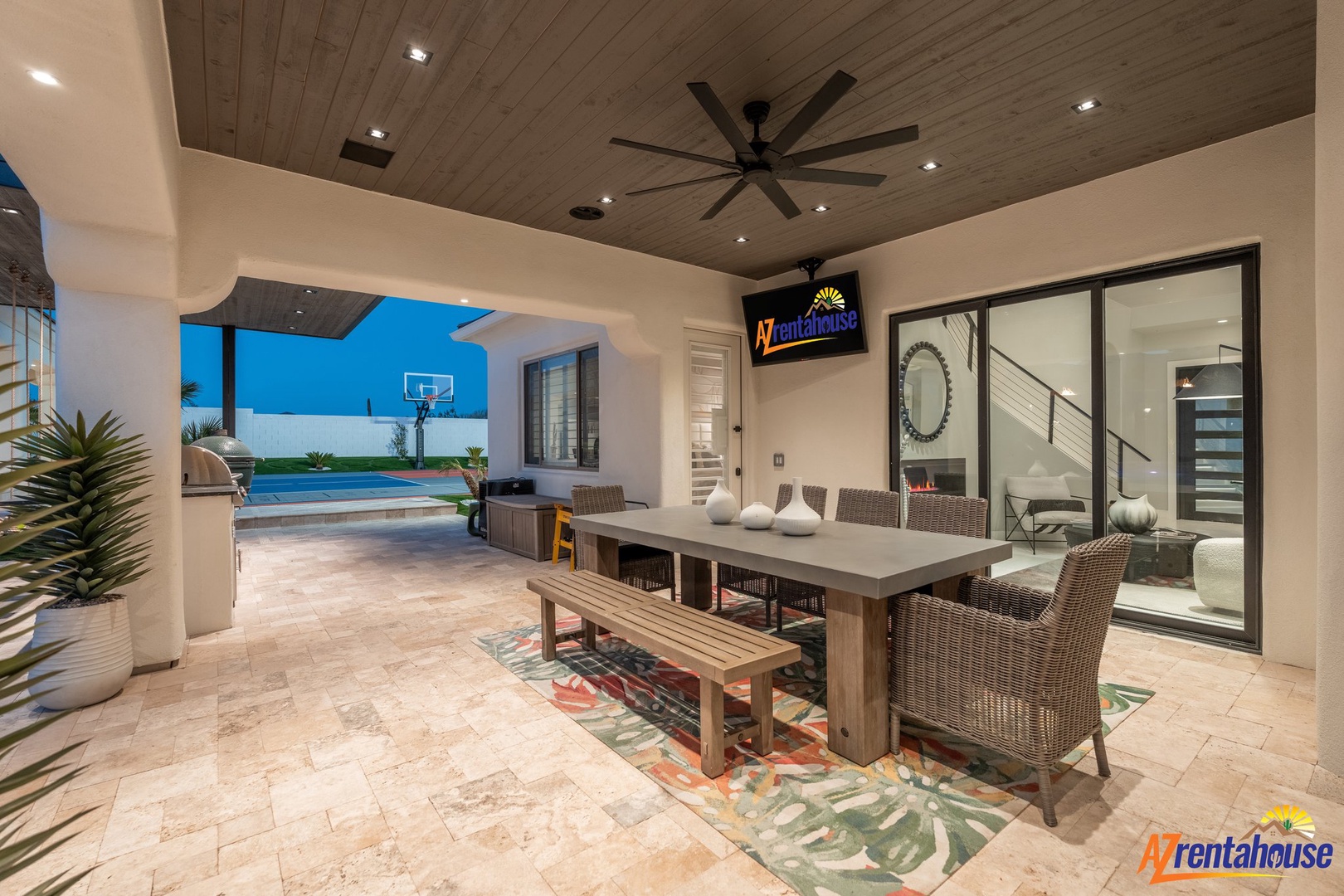 Your covered outdoor dining space opens to a sparkling pool, perfect for enjoying meals while staying cool under the stylish ceiling fan.