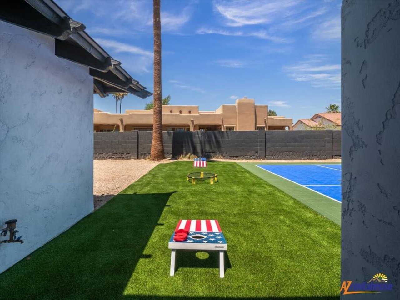 Step into your private backyard oasis featuring lush green lawn, perfect for cornhole tournaments and poolside relaxation under Arizona's endless blue skies.